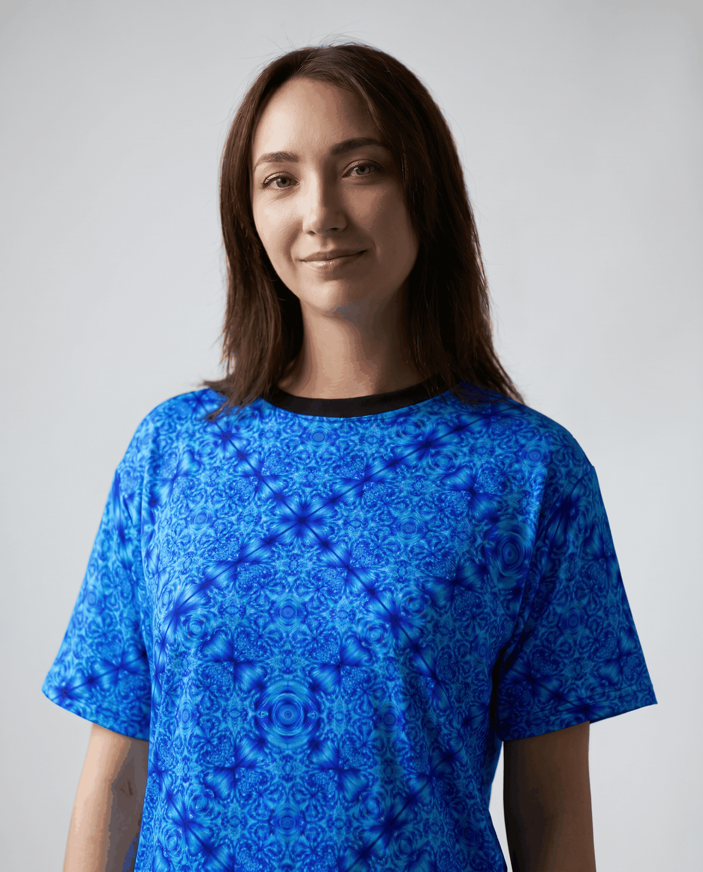 Blue kaleidoscope all-over print tee with intricate glacier-blue motifs and ribbed collar
