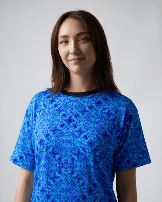 Blue kaleidoscope all-over print tee with intricate glacier-blue motifs and ribbed collar