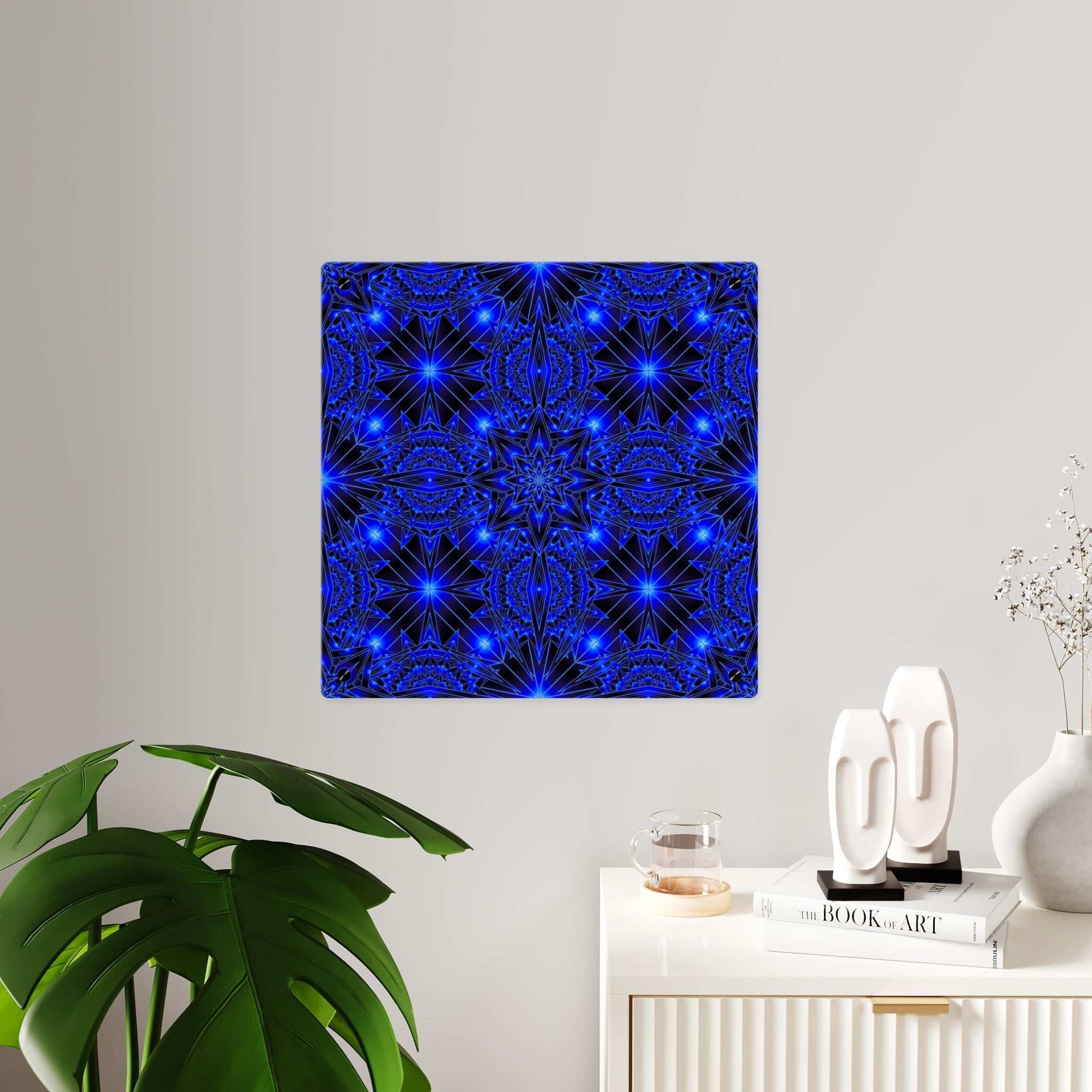 Blue kaleidoscope acrylic wall art panel with geometric starburst design on glossy clear surface mounted on silver stand-offs